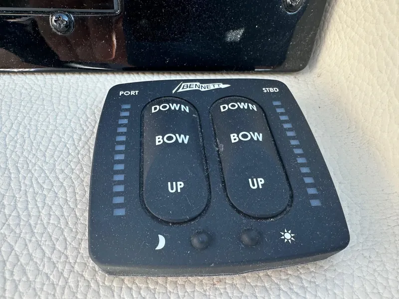 Slide: The Image of Bennett trim tab control panel on 2023 Regal 2800 boat dashboard. - 41