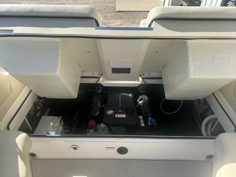 Slide: The Image of 2023 Regal 2800 boat engine compartment with open hatch, showcasing engine components. - 45