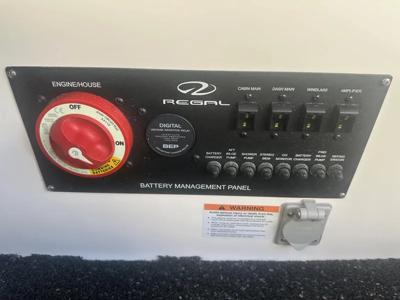 Slide: The Image of 2023 Regal 2800 battery management panel with switches and warning label. - 47