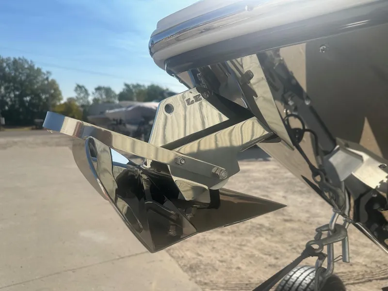 Slide: The Image of 2023 Regal 2800 boat anchor detail in sunlight, showcasing polished metal finish. - 6