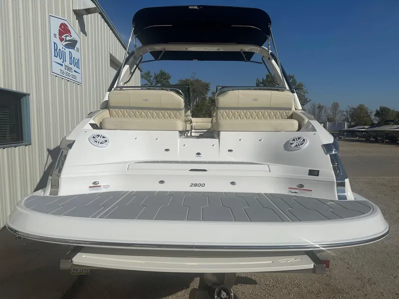 Slide: The Image of 2023 Regal 2800 boat with beige seating and blue canopy at Boji Boat Brokers. - 7