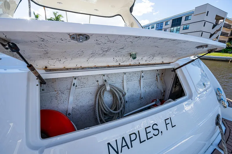Slide: The Image of Open storage compartment on 2002 Sea Ray 510 Sundancer, Naples, FL, with rope and buoy. - 15