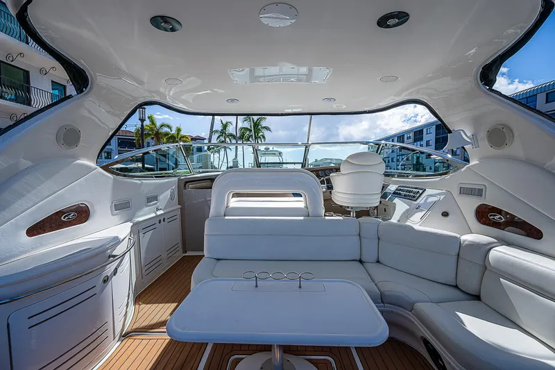 Slide: The Image of Luxurious interior of 2002 Sea Ray 510 Sundancer yacht with white seating and wooden flooring. - 19