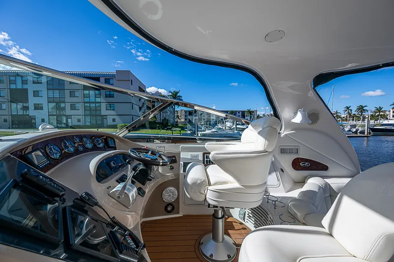 Slide: The Image of Luxurious 2002 Sea Ray 510 Sundancer yacht cockpit with modern controls and plush seating. - 22