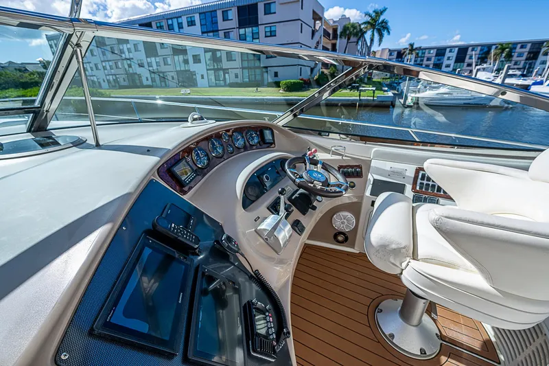 Slide: The Image of Luxurious 2002 Sea Ray 510 Sundancer yacht helm with modern controls and waterfront view. - 23