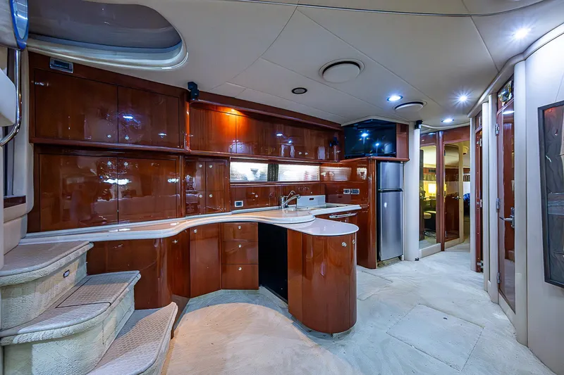 Slide: The Image of Luxurious interior of 2002 Sea Ray 510 Sundancer yacht with modern kitchen amenities. - 25