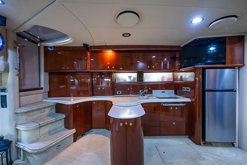 Slide: The Image of Luxurious 2002 Sea Ray 510 Sundancer yacht interior with modern kitchen and elegant wood finishes. - 26