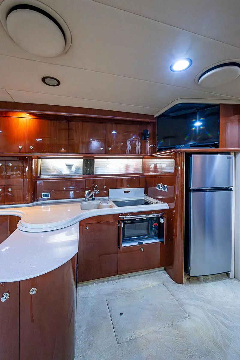 Slide: The Image of Luxurious 2002 Sea Ray 510 Sundancer yacht kitchen with modern appliances and sleek cabinetry. - 30