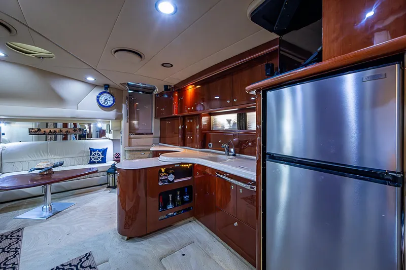 Slide: The Image of Luxurious interior of 2002 Sea Ray 510 Sundancer yacht with modern kitchen and seating area. - 32