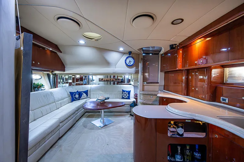 Slide: The Image of Luxurious interior of 2002 Sea Ray 510 Sundancer yacht with elegant seating and wooden cabinetry. - 33