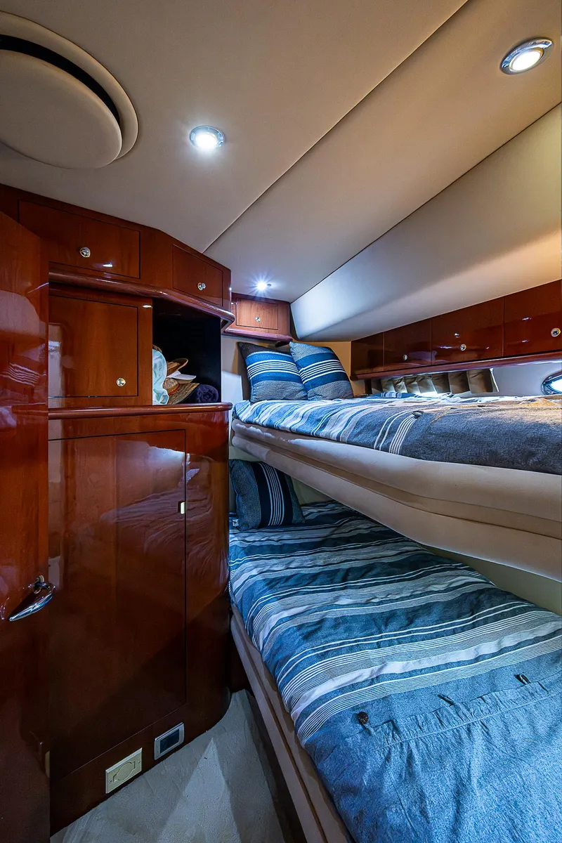 Slide: The Image of Interior cabin of 2002 Sea Ray 510 Sundancer with bunk beds and wood cabinetry. - 35