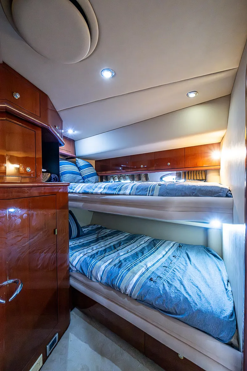 Slide: The Image of Luxurious 2002 Sea Ray 510 Sundancer cabin with cozy bunk beds and elegant wood finish. - 36