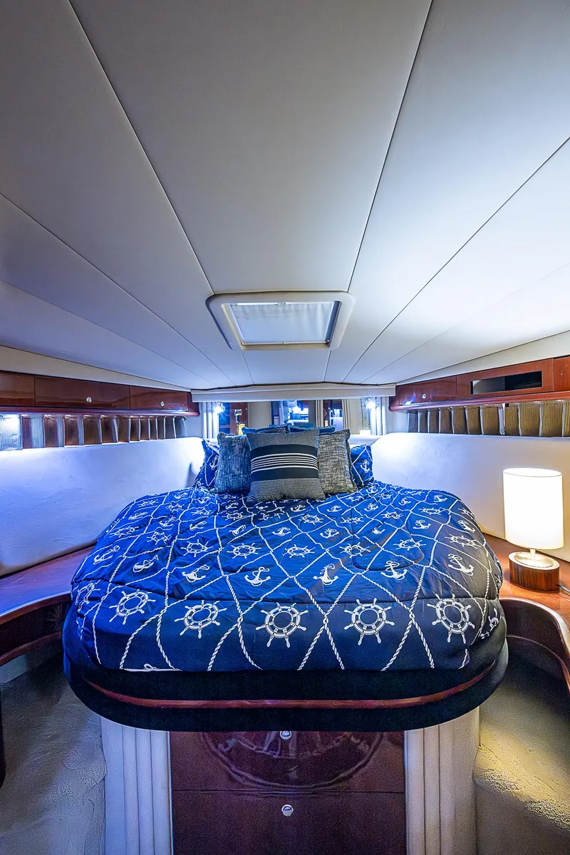 Slide: The Image of Luxurious 2002 Sea Ray 510 Sundancer cabin with nautical-themed bedding. - 42