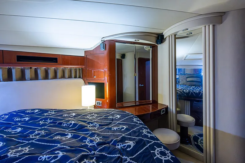 Slide: The Image of Luxurious cabin interior of 2002 Sea Ray 510 Sundancer yacht with nautical-themed bedding. - 45
