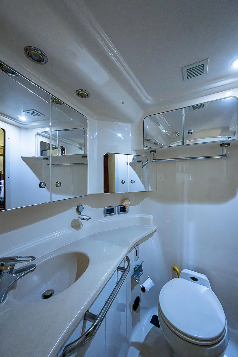 Slide: The Image of Luxurious bathroom in 2002 Sea Ray 510 Sundancer yacht, featuring modern fixtures and ample storage. - 46
