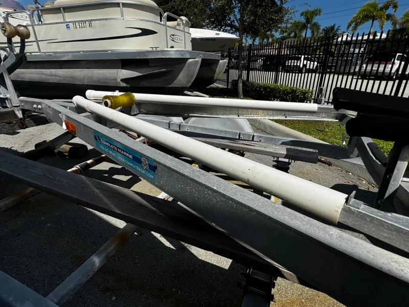 Slide: The Image of 2019 Continental Trailers Single Axel with boat, parked outdoors. - 3