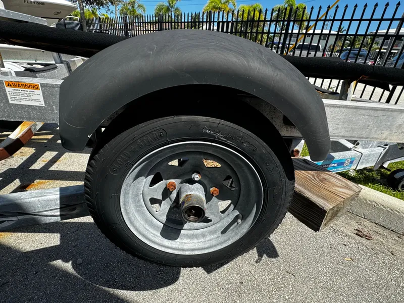 Slide: The Image of 2019 Continental Trailers Single Axel tire and wheel on pavement, with metal fender. - 4