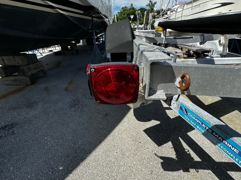 Slide: The Image of 2019 Continental Trailers Single Axel with red tail light in a boatyard. - 5