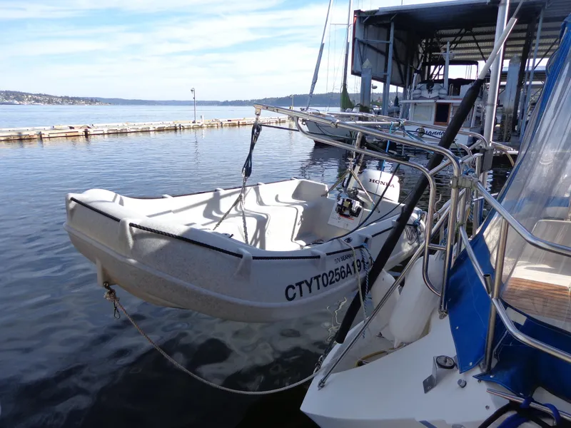 Slide: The Image of Catalina MK-l Double Cabin 1991 docked at marina, calm waters, clear sky. - 2