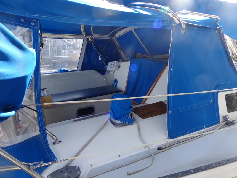 Slide: The Image of 1991 Catalina MK-l Double Cabin with blue canopy and seating area. - 6