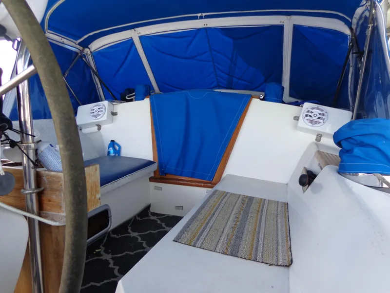 Slide: The Image of 1991 Catalina MK-l Double Cabin interior with blue canopy and seating area. - 10