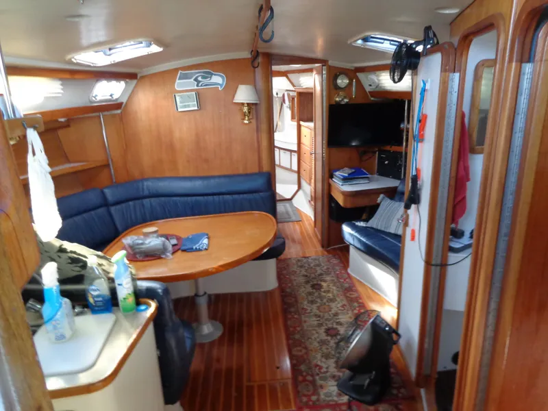 Slide: The Image of Interior of 1991 Catalina MK-l Double Cabin with wood paneling and blue seating. - 12