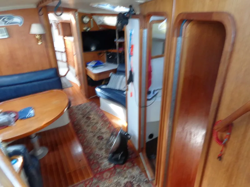 Slide: The Image of Interior of 1991 Catalina MK-l Double Cabin with wooden furnishings and blue seating. - 13
