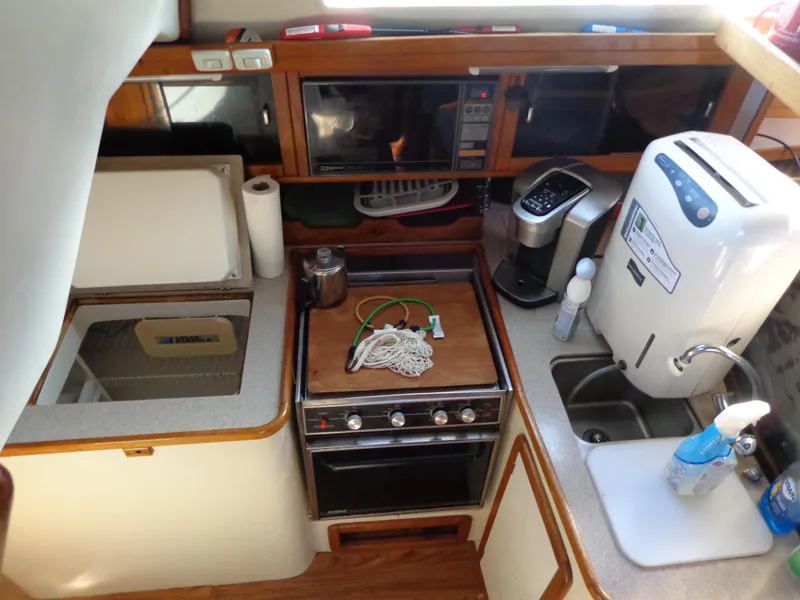 Slide: The Image of 1991 Catalina MK-l Double Cabin kitchen with stove, sink, and appliances. - 14