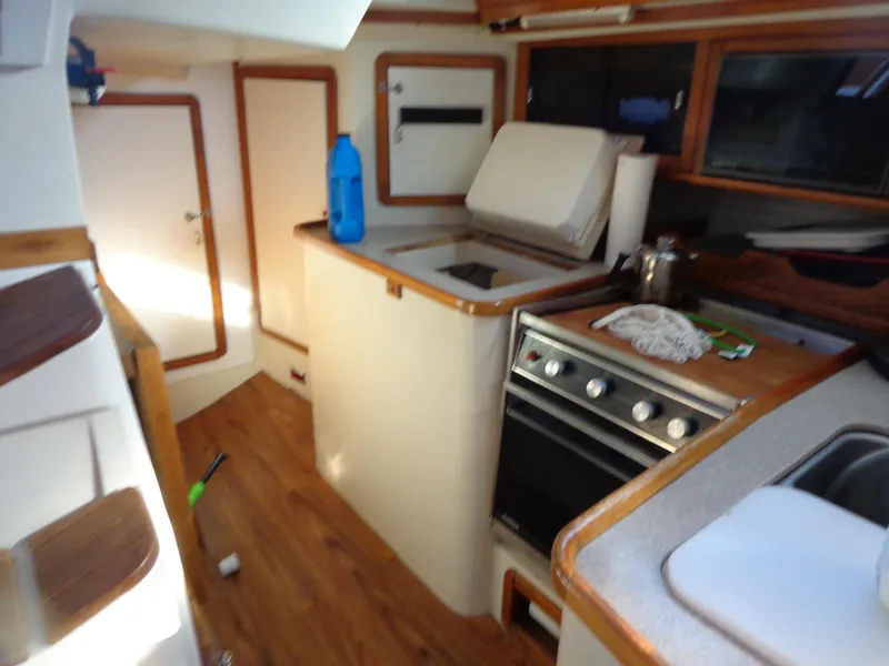 Slide: The Image of Interior of 1991 Catalina MK-l Double Cabin with kitchen and wooden flooring. - 15