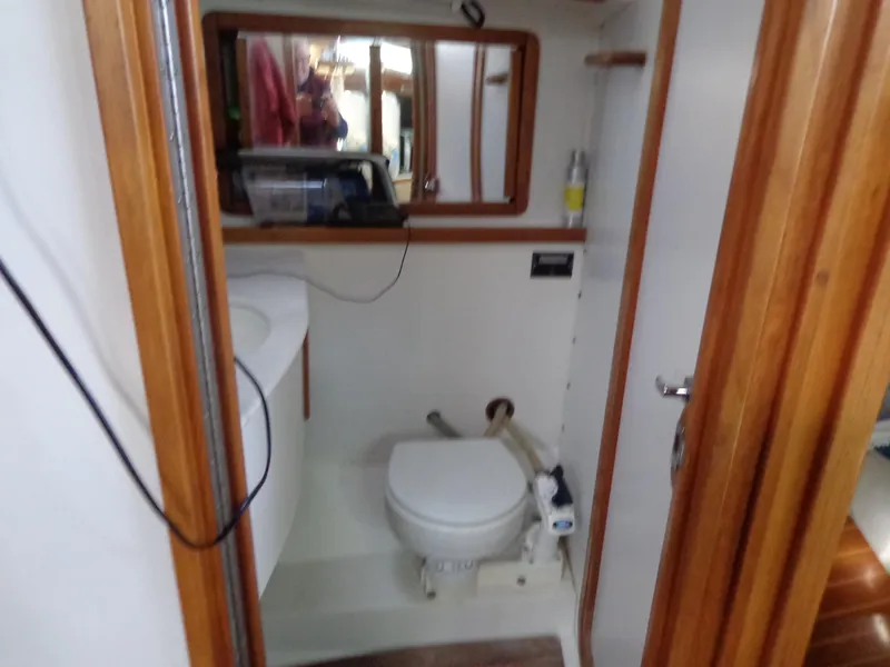 Slide: The Image of 1991 Catalina MK-l Double Cabin bathroom with wooden trim and compact design. - 17