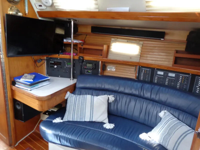 Slide: The Image of Interior of 1991 Catalina MK-l Double Cabin with blue seating and navigation equipment. - 18