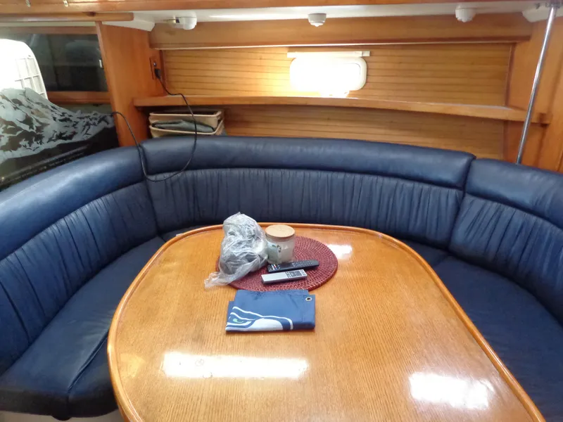 Slide: The Image of Cozy dining area in 1991 Catalina MK-l Double Cabin yacht with blue seating. - 19