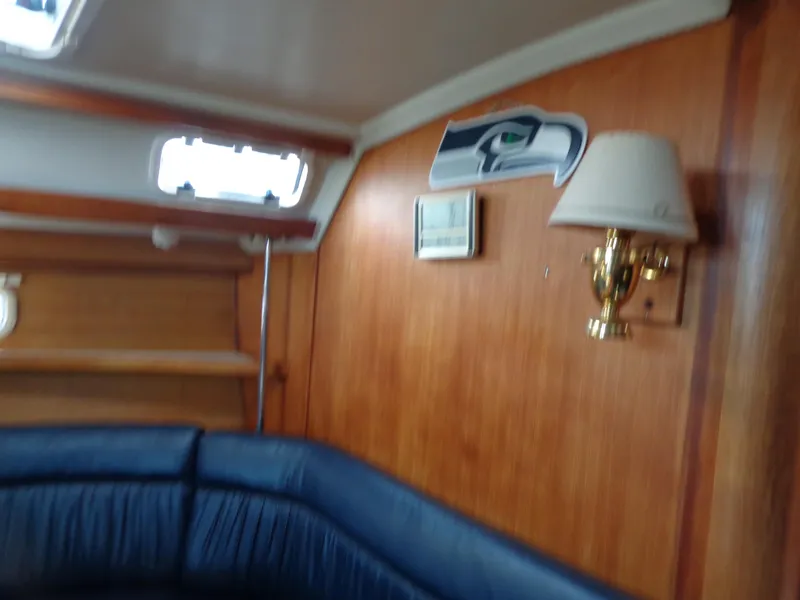 Slide: The Image of Interior of 1991 Catalina MK-l Double Cabin with blue seating and wooden paneling. - 20
