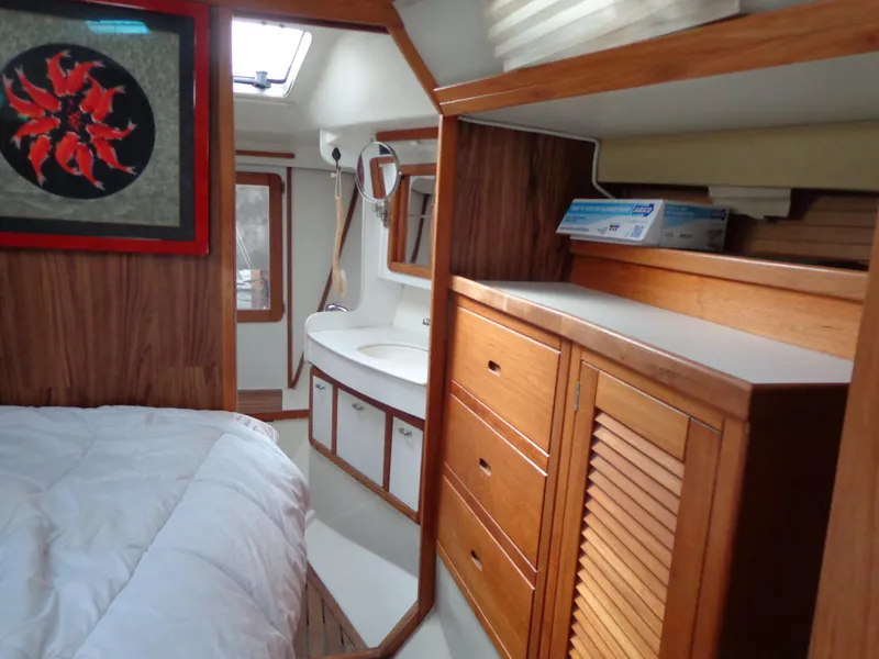 Slide: The Image of 1991 Catalina MK-l Double Cabin interior with wood cabinetry and cozy bed. - 23