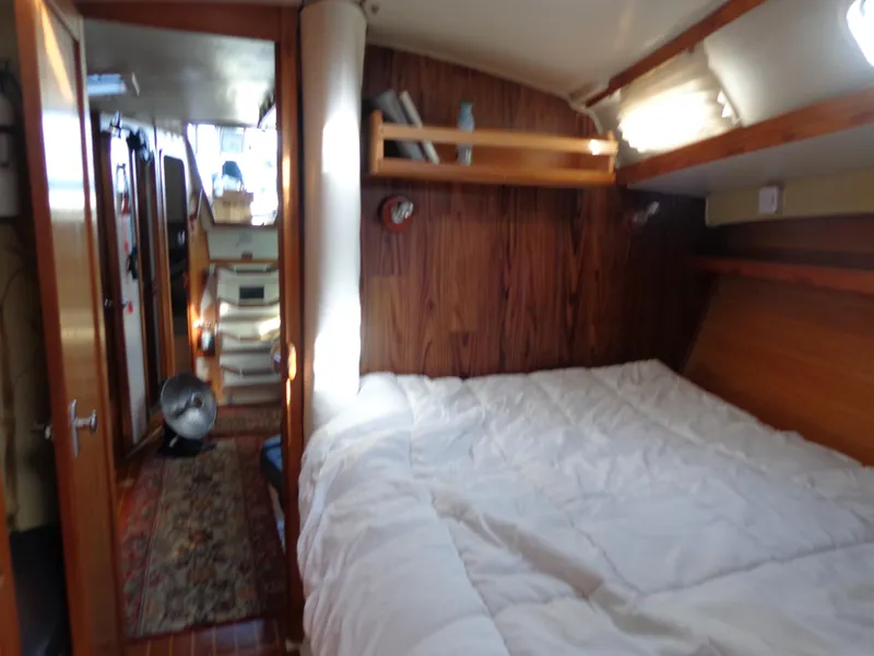 Slide: The Image of Cozy interior of 1991 Catalina MK-l Double Cabin with bed and wooden accents. - 25