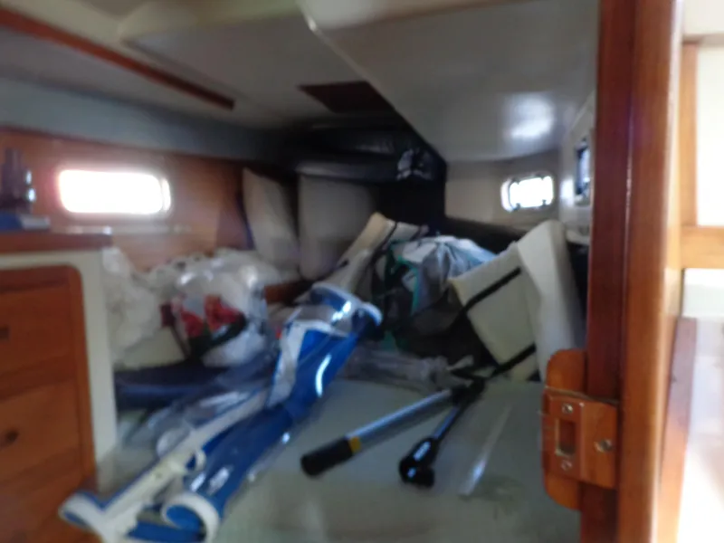Slide: The Image of Interior of 1991 Catalina MK-l Double Cabin with scattered items and equipment. - 29