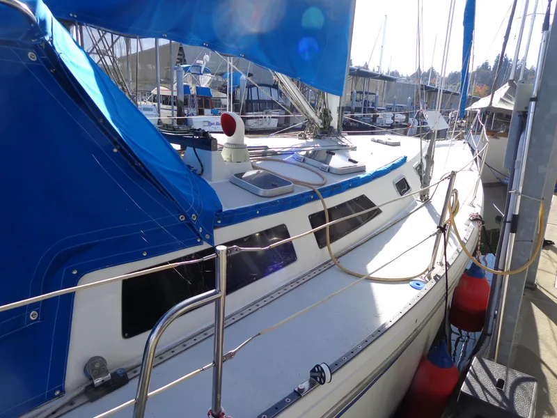 Slide: The Image of 1991 Catalina MK-l Double Cabin sailboat docked with blue covers. - 3
