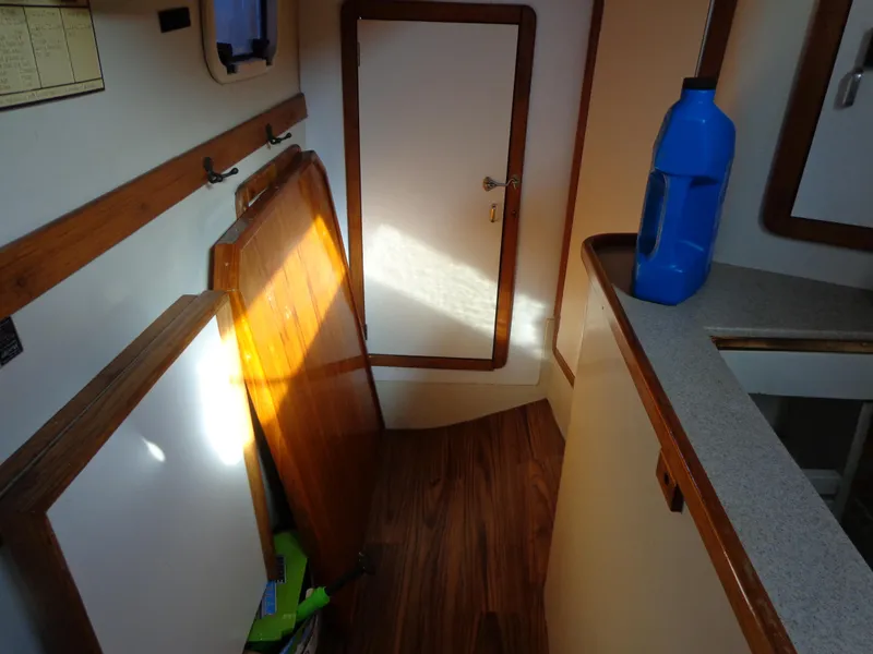 Slide: The Image of Interior of 1991 Catalina MK-l Double Cabin with wooden flooring and blue bottle. - 30