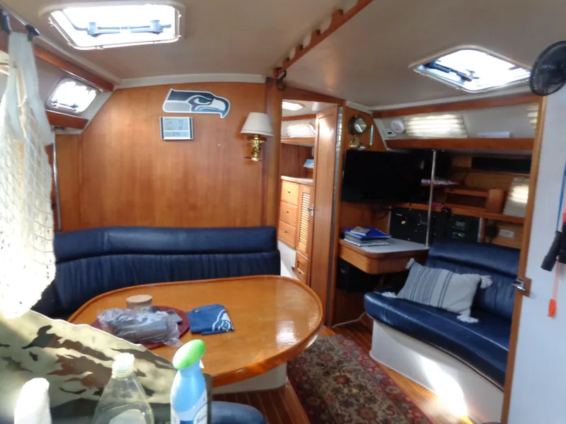 Slide: The Image of Interior of 1991 Catalina MK-l Double Cabin with cozy seating and nautical decor. - 31