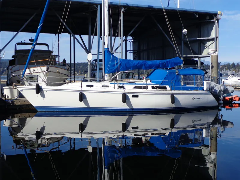 Slide: The Image of 1991 Catalina MK-l Double Cabin yacht docked in marina, reflecting on calm water. - 32