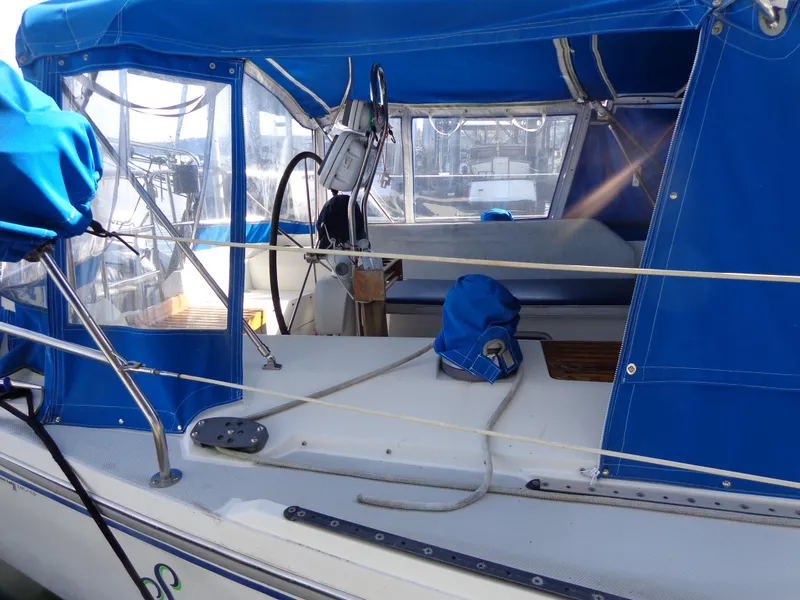 Slide: The Image of 1991 Catalina MK-l Double Cabin sailboat with blue canopy and cockpit view. - 5