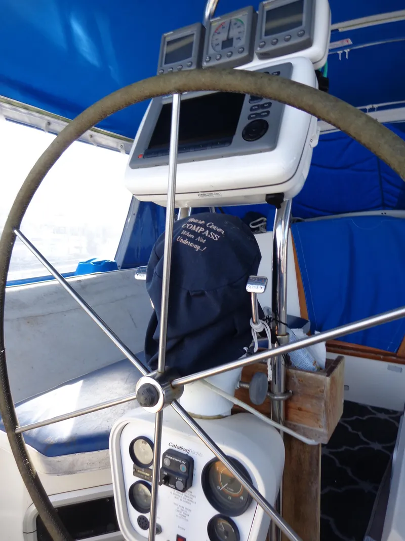 Slide: The Image of 1991 Catalina MK-l Double Cabin yacht helm with navigation instruments and blue canopy. - 7
