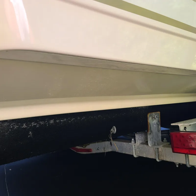 Slide: The Image of Close-up of 2015 Pursuit DC 235 Dual Console boat on trailer. - 16