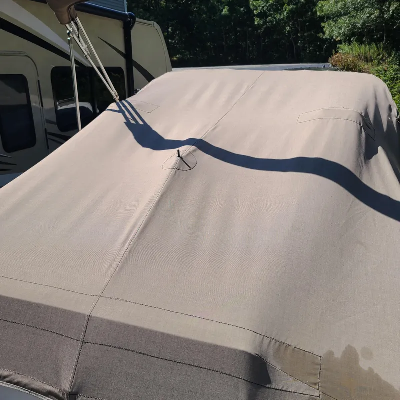 Slide: The Image of 2015 Pursuit DC 235 Dual Console boat covered with a protective tarp. - 19
