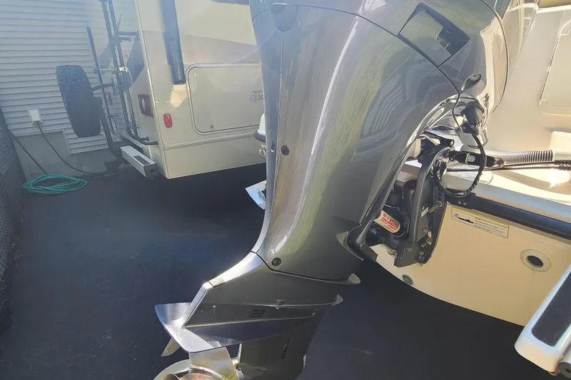 Slide: The Image of 2015 Pursuit DC 235 Dual Console boat engine in a driveway. - 20