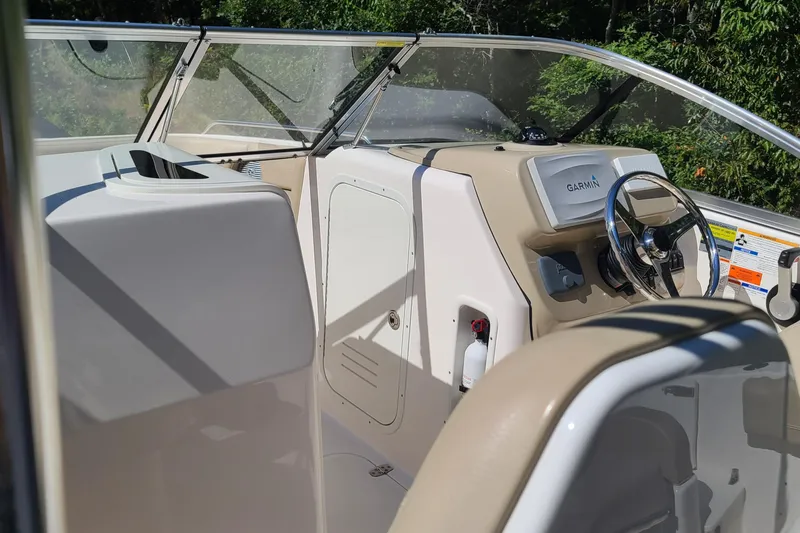 Slide: The Image of 2015 Pursuit DC 235 Dual Console boat interior with steering wheel and dashboard. - 21