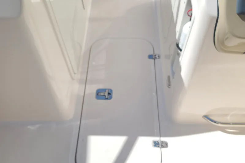 Slide: The Image of 2015 Pursuit DC 235 Dual Console boat deck with storage hatch. - 26