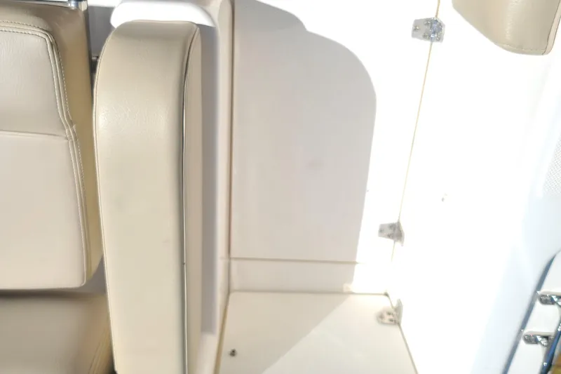 Slide: The Image of 2015 Pursuit DC 235 Dual Console interior seating and storage area. - 33