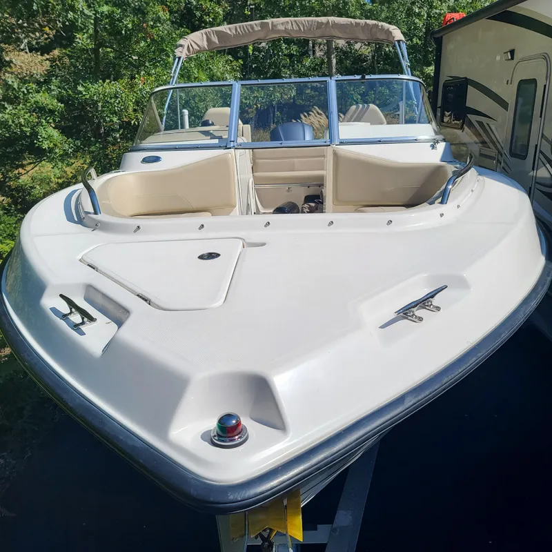 Slide: The Image of 2015 Pursuit DC 235 Dual Console boat, white exterior, parked outdoors. - 6
