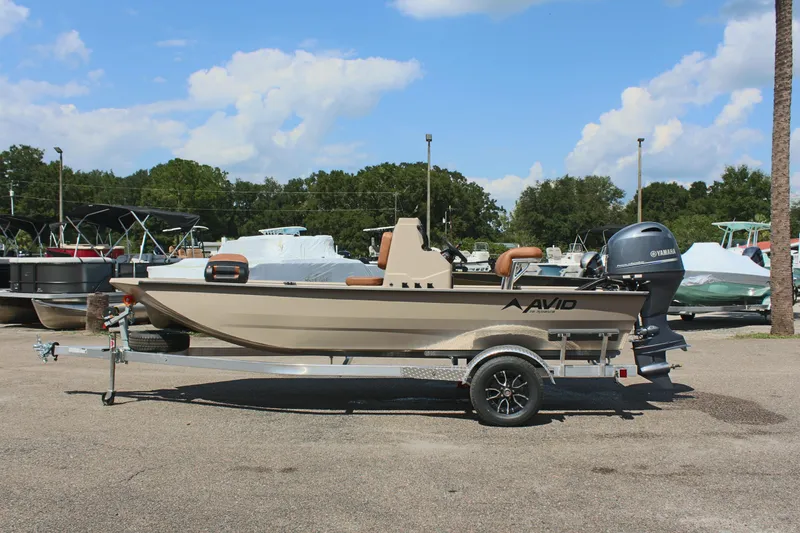 The Image of 2025 Avid 18 Rogue CC boat on trailer, parked outdoors under a blue sky. - 1